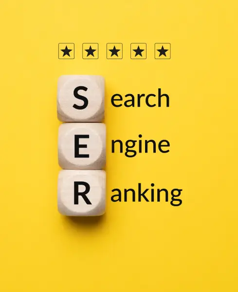 hree white wooden dice stacked on a yellow background spell "S E R" next to the words "search engine ranking" with four black stars above, indicating a high rating