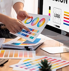 Graphic designer work on computer laptop and with graphic drawing pen while brainstorming unique design with professional graphic team in modern digital studio workplace